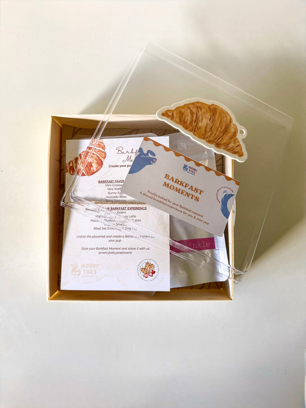 Inside Barkfast Moment showing breakfast-inspired dog treats, Berry Sprinkle, menu card and placemat.