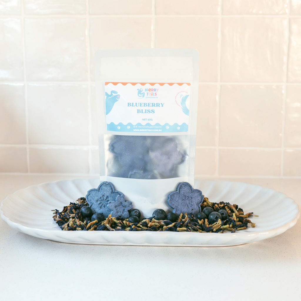 Merry Tails Blueberry Bliss dog treats packaging with blueberry-shaped biscuits and fresh blueberries