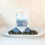 Merry Tails Blueberry Bliss dog treats packaging with blueberry-shaped biscuits and fresh blueberries