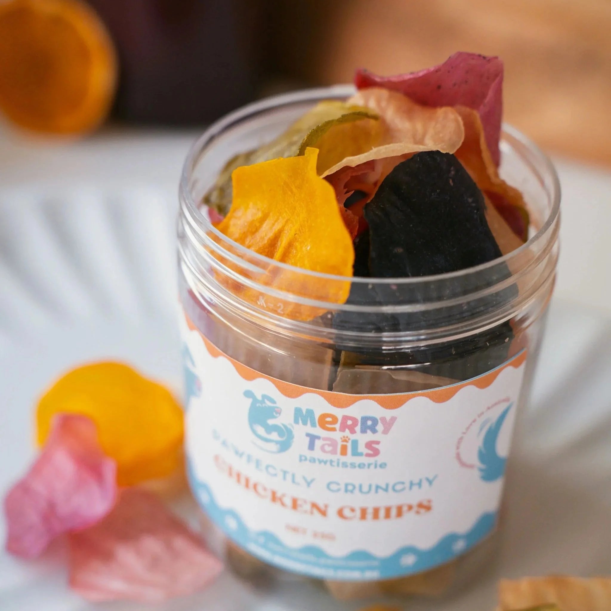 Angled close-up of a jar of crunchy chicken dog treats on a kitchen counter