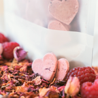 Handmade raspberry and rose dog biscuits with packaging, heart-shaped natural treats