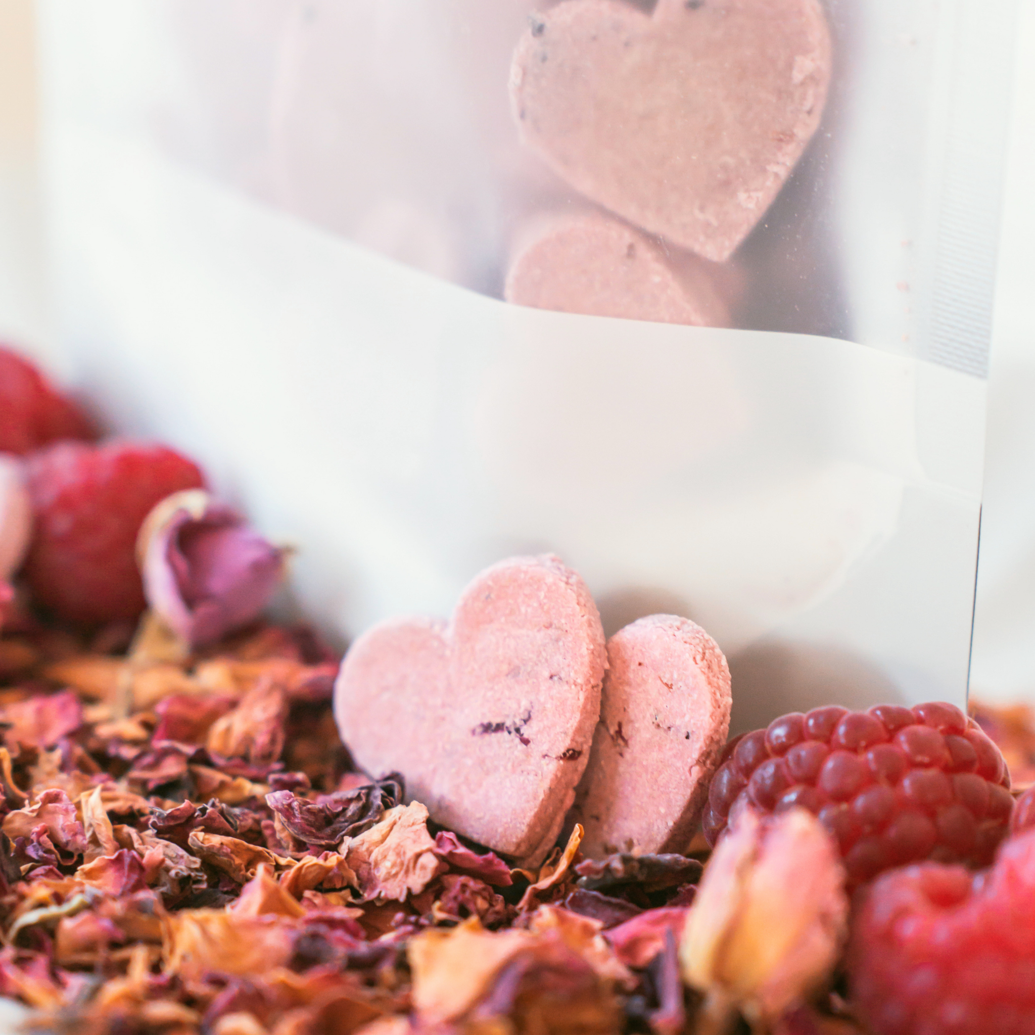 Handmade raspberry and rose dog biscuits with packaging, heart-shaped natural treats