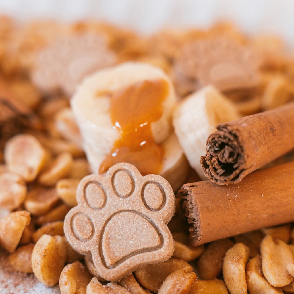 Peanut butter paw dog treats with banana and peanut butter drizzle close up