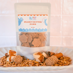 Handmade dog biscuits with peanut butter, banana and cinnamon in front of packaging