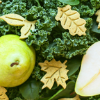 Close-up of leaf-shaped pear dog cookies with kale and spinach